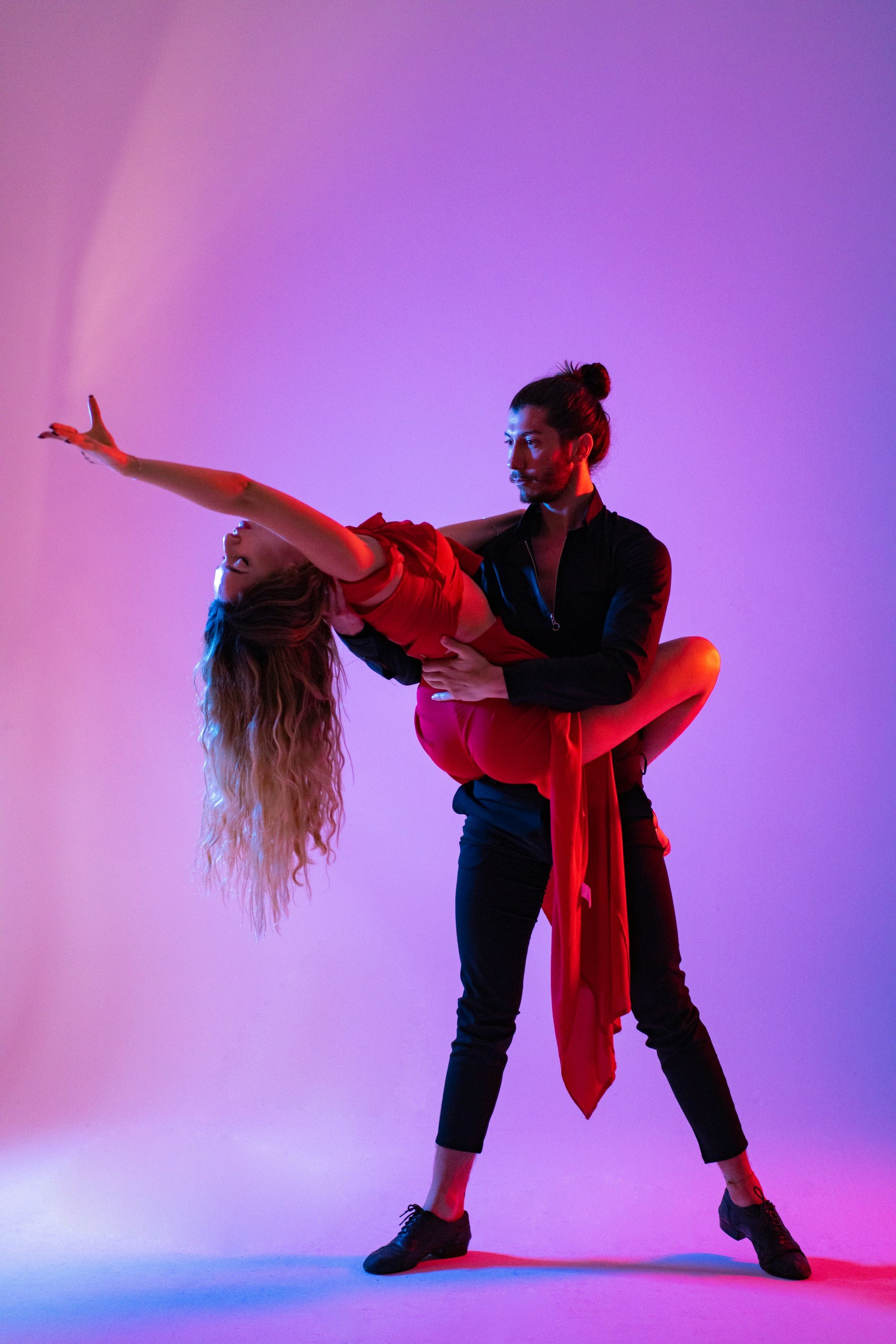 A couple dancing closely, caught mid-movement