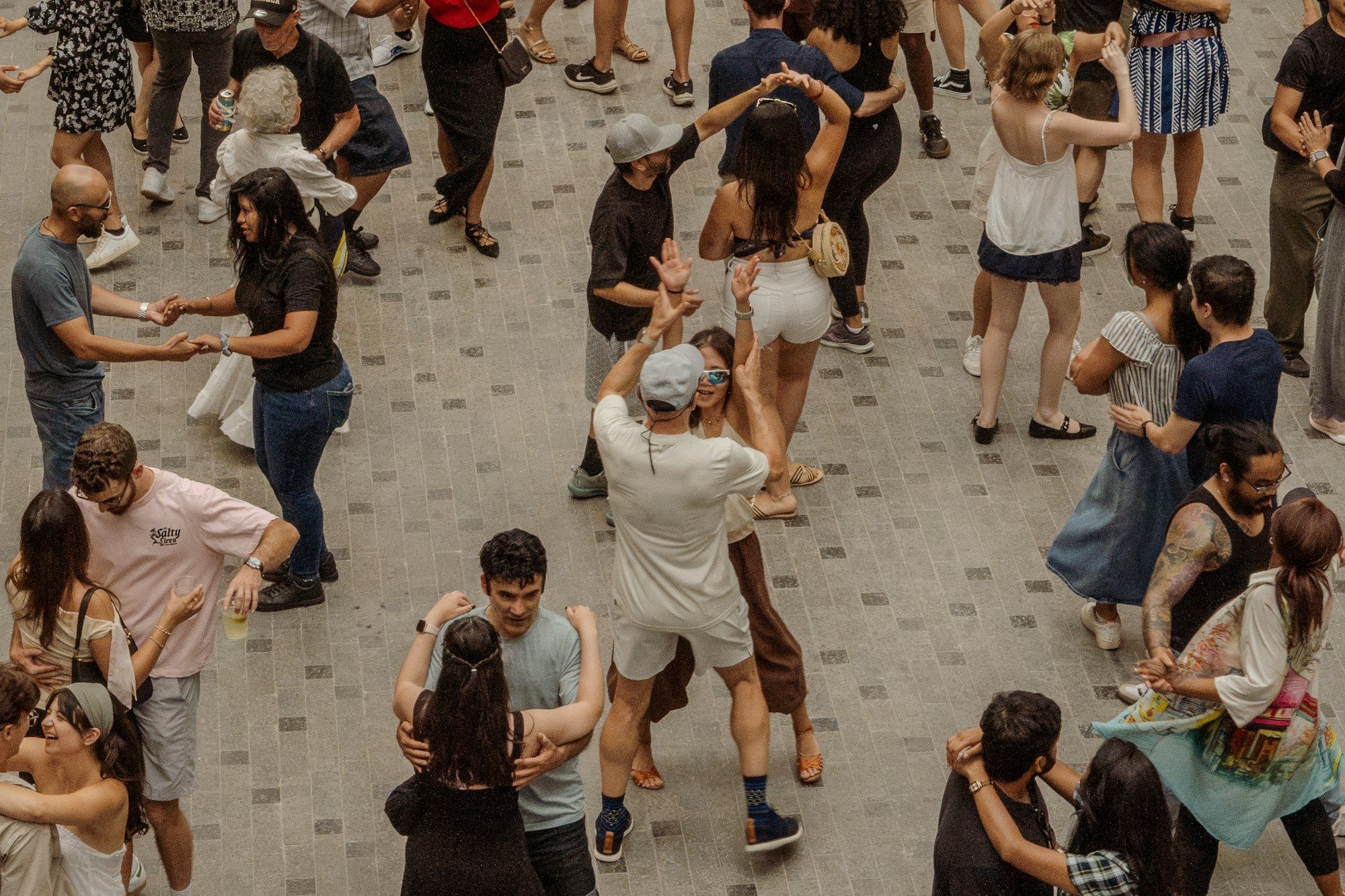 A group of people dancing together outdoors